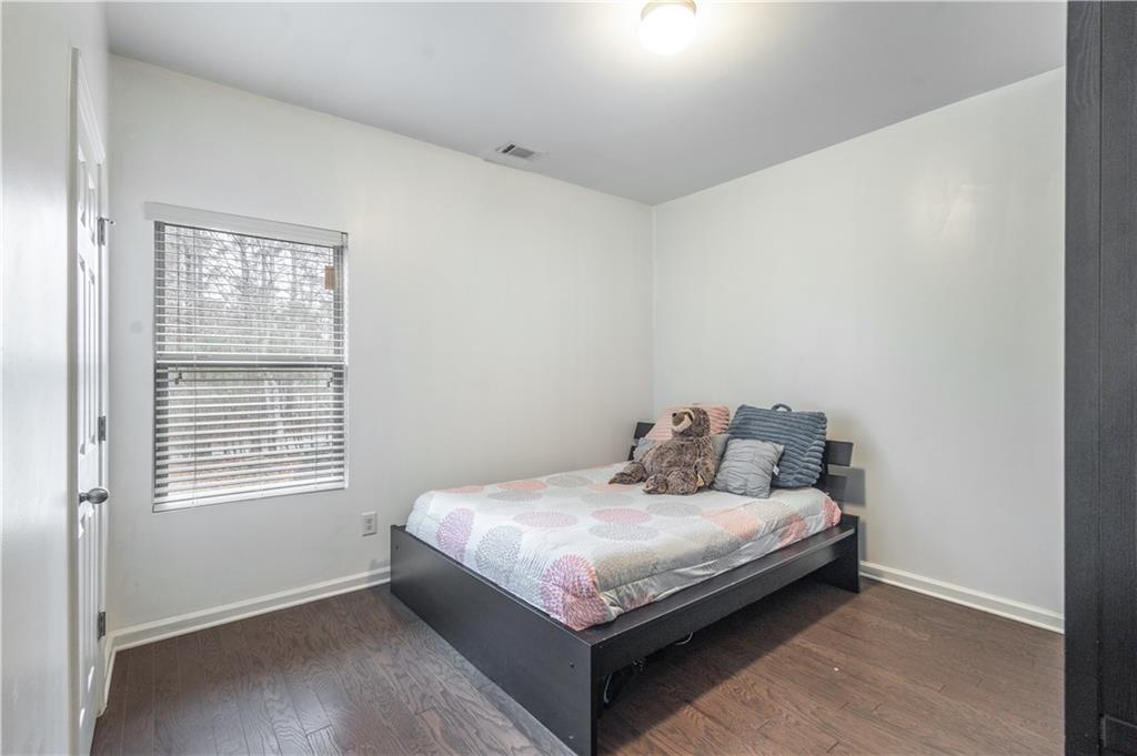 21 Sunny Point Newnan, GA 30263 - Photo 14 of 33 a bed sitting in a bedroom next to a window