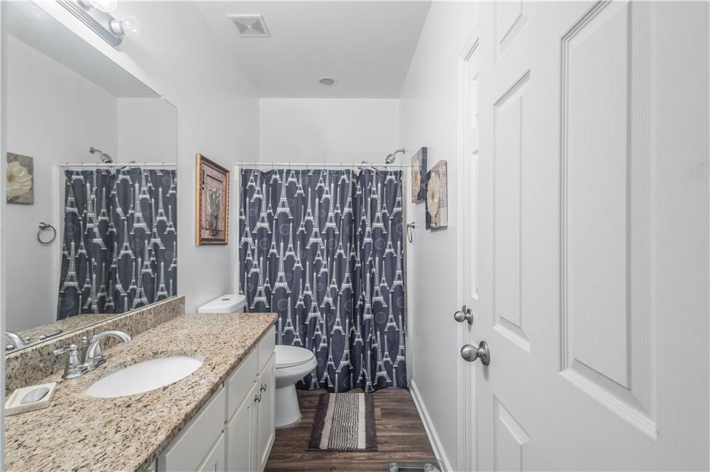 21 Sunny Point Newnan, GA 30263 - Photo 16 of 33 a bathroom with a granite countertop shower a sink and a mirror