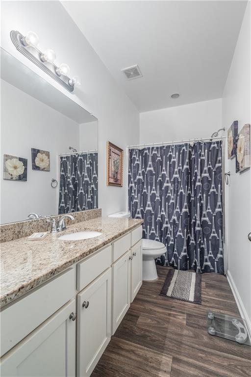 21 Sunny Point Newnan, GA 30263 - Photo 17 of 33 a spacious bathroom with a granite countertop sink a toilet and a mirror