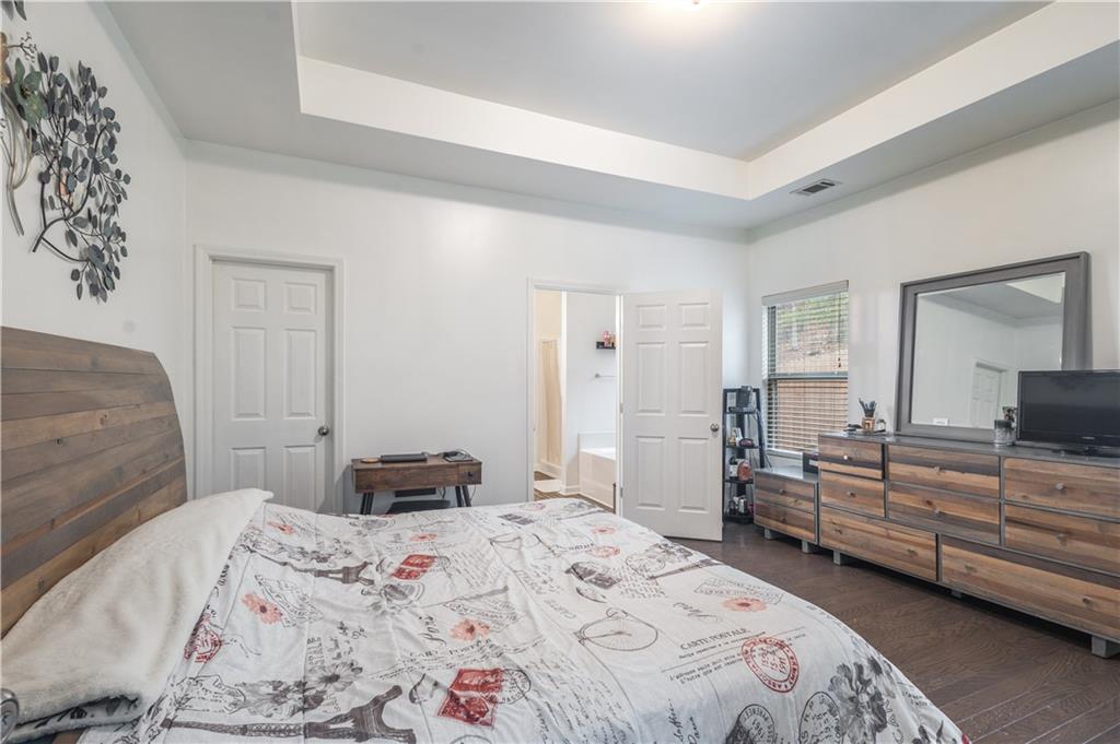 21 Sunny Point Newnan, GA 30263 - Photo 19 of 33 a bedroom with a bed and a dresser