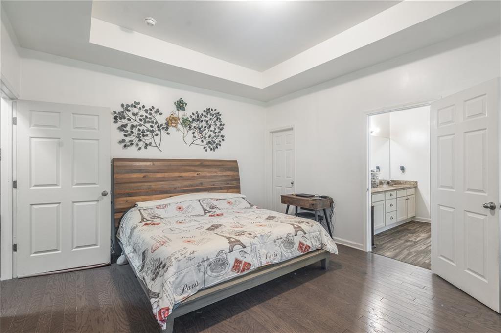 21 Sunny Point Newnan, GA 30263 - Photo 20 of 33 a bedroom with a bed and wooden floor