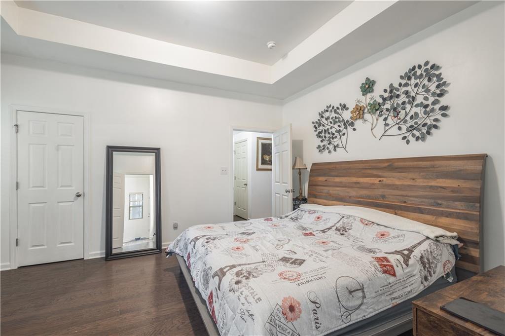 21 Sunny Point Newnan, GA 30263 - Photo 21 of 33 a bedroom with a bed and a painting on the wall