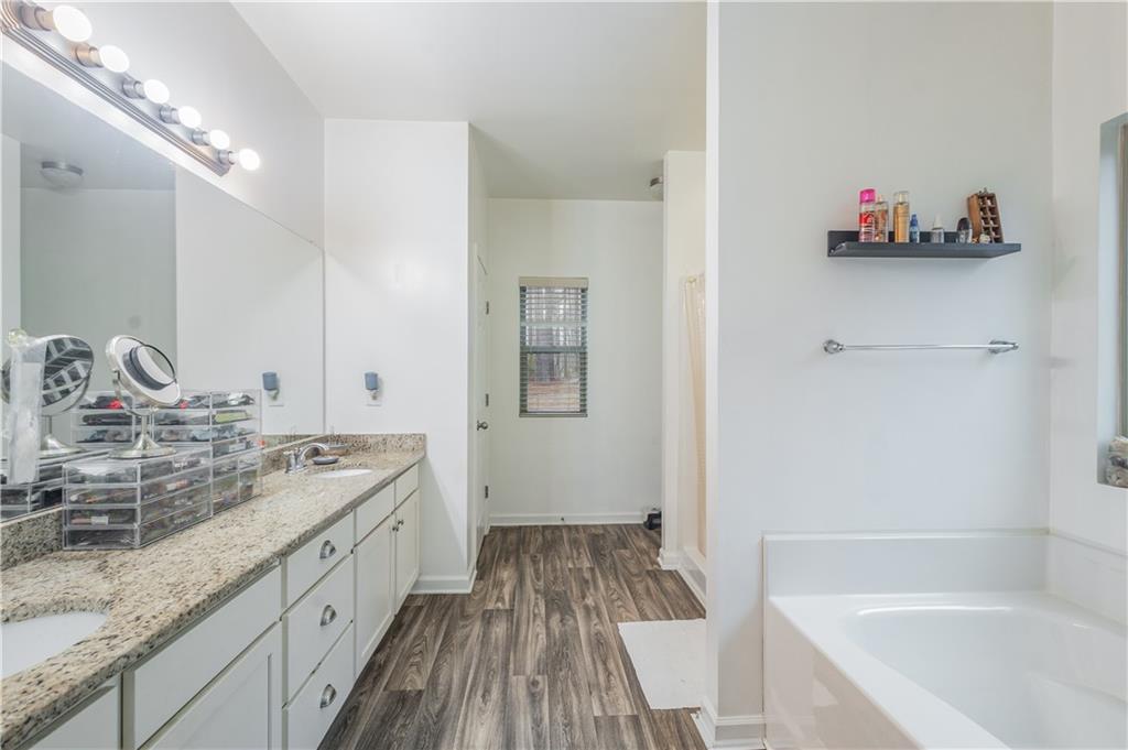 21 Sunny Point Newnan, GA 30263 - Photo 23 of 33 a bathroom with a tub sink and mirror