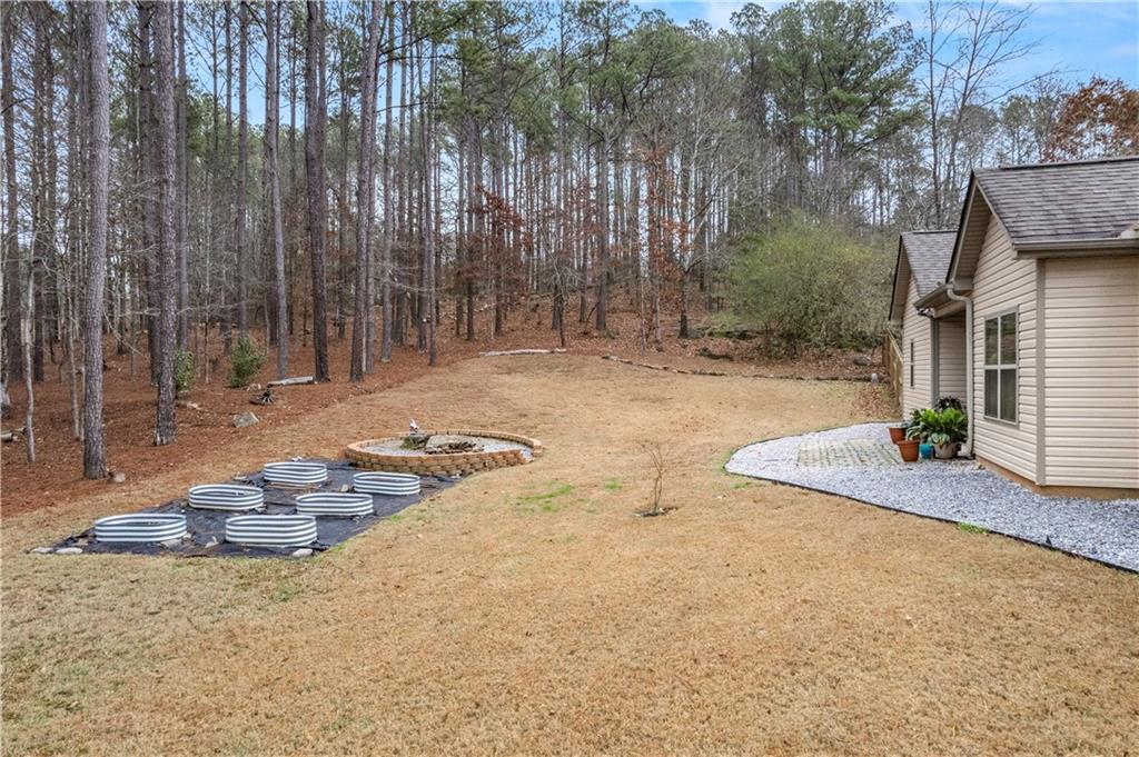 21 Sunny Point Newnan, GA 30263 - Photo 29 of 33 a backyard of a house with table and chairs