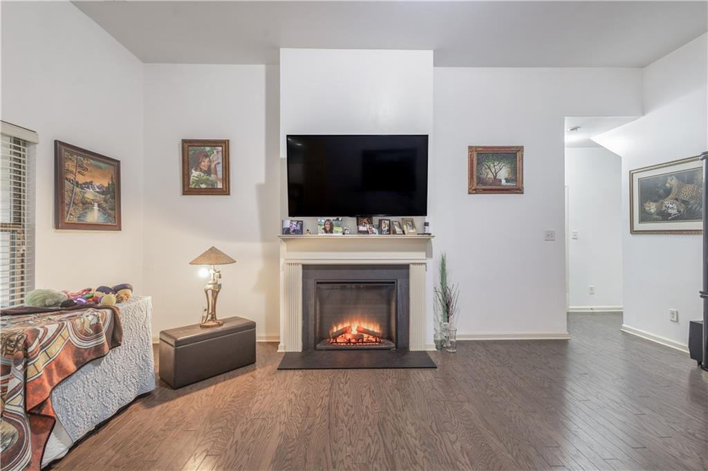 21 Sunny Point Newnan, GA 30263 - Photo 3 of 33 a living room with furniture a flat screen tv and a fireplace