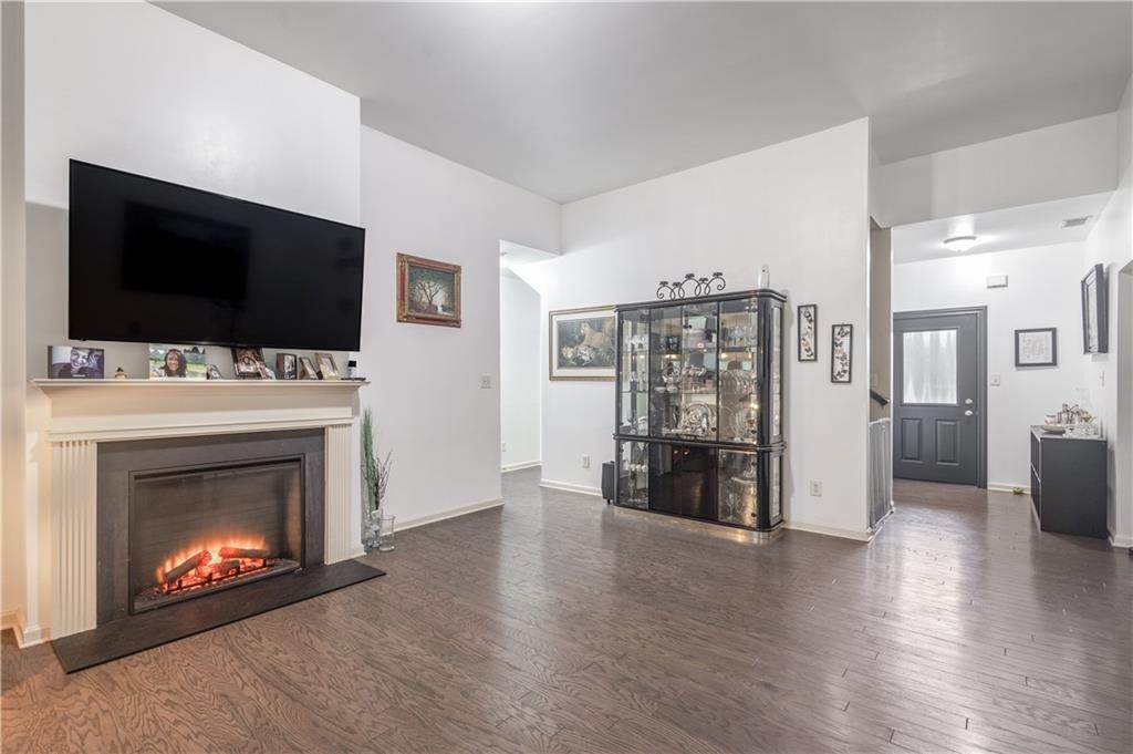 21 Sunny Point Newnan, GA 30263 - Photo 4 of 33 a living room with furniture a flat screen tv and a fireplace