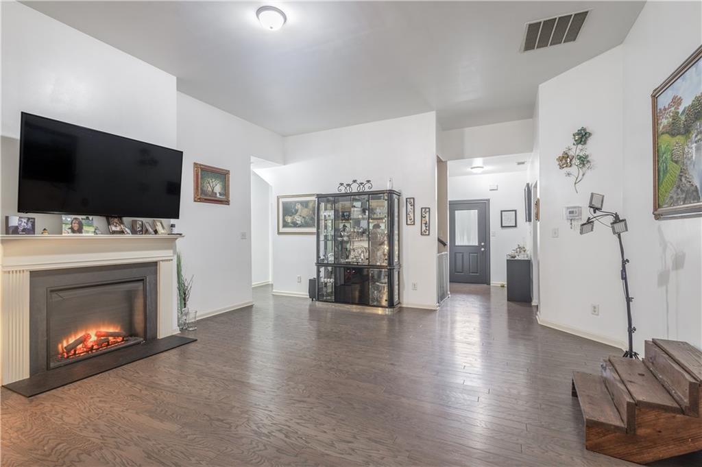 21 Sunny Point Newnan, GA 30263 - Photo 5 of 33 a view of a livingroom with a fireplace wooden floor and a flat screen tv