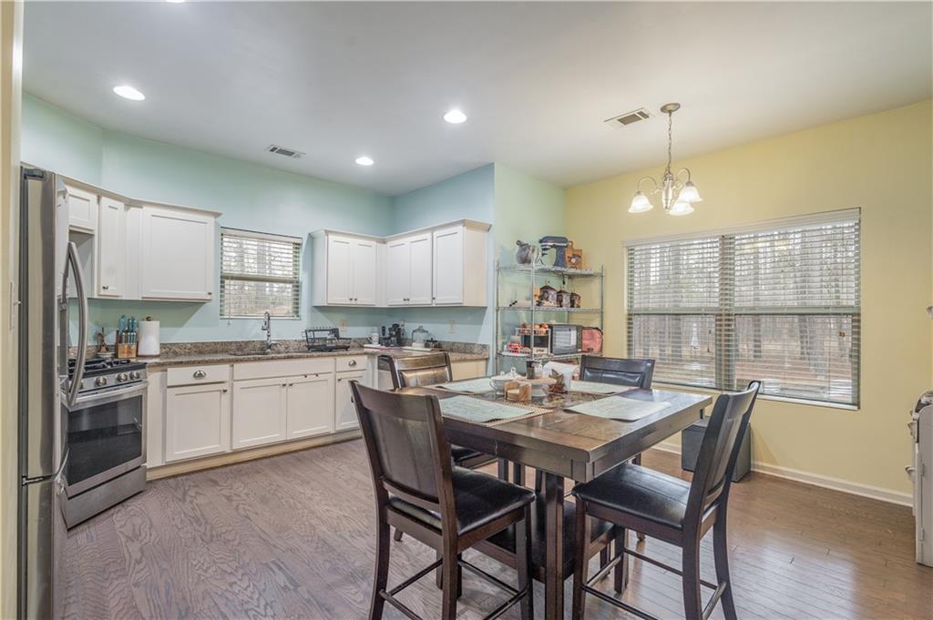 21 Sunny Point Newnan, GA 30263 - Photo 6 of 33 a kitchen with a table and chairs in it