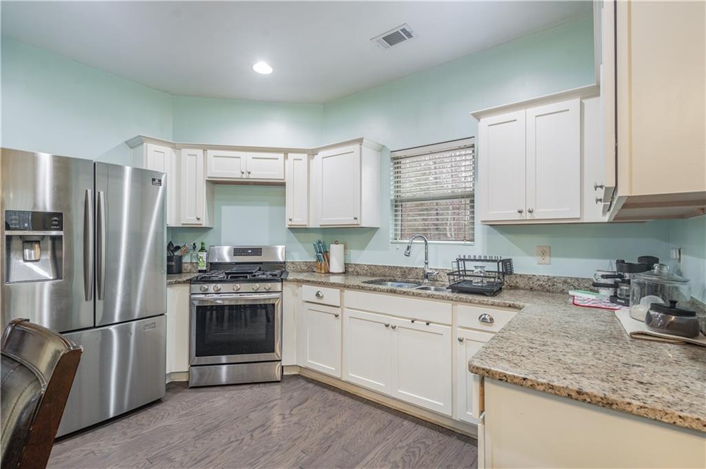 21 Sunny Point Newnan, GA 30263 - Photo 7 of 33 a kitchen with a sink stove and refrigerator