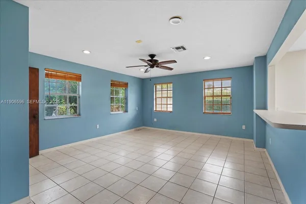 a view of hallway with a window and a refrigerator