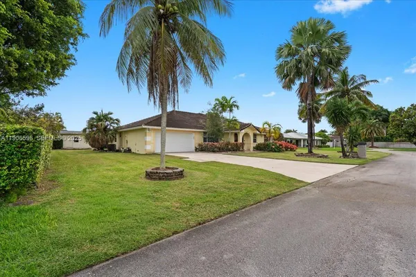 an aerial view of a house with garden space and street view