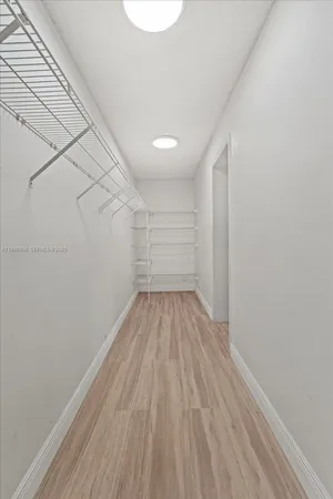 a large kitchen with stainless steel appliances a large counter top and a stove