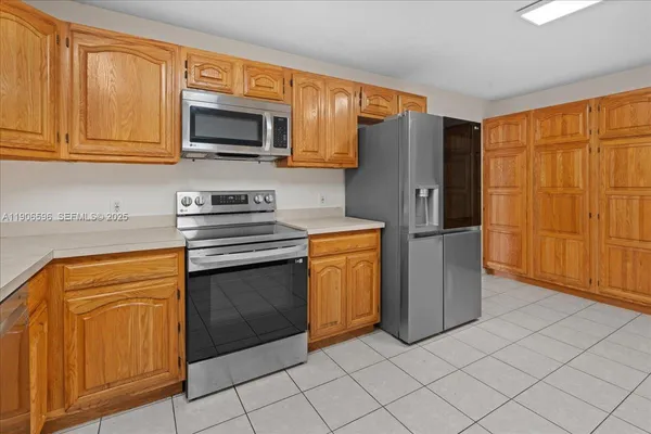a aerial view of a house with a yard and potted plants
