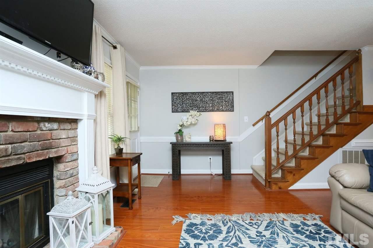 4518 Hamptonshire Drive Raleigh, NC 27613 - Photo 11 of 24 a living room with fireplace furniture and a wooden floor