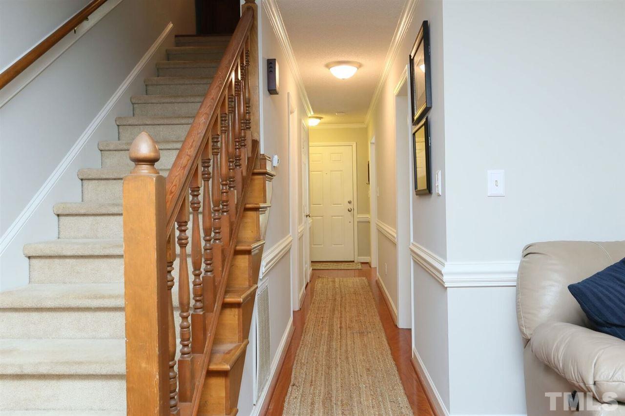 4518 Hamptonshire Drive Raleigh, NC 27613 - Photo 12 of 24 a view of a hallway with wooden floor and staircase