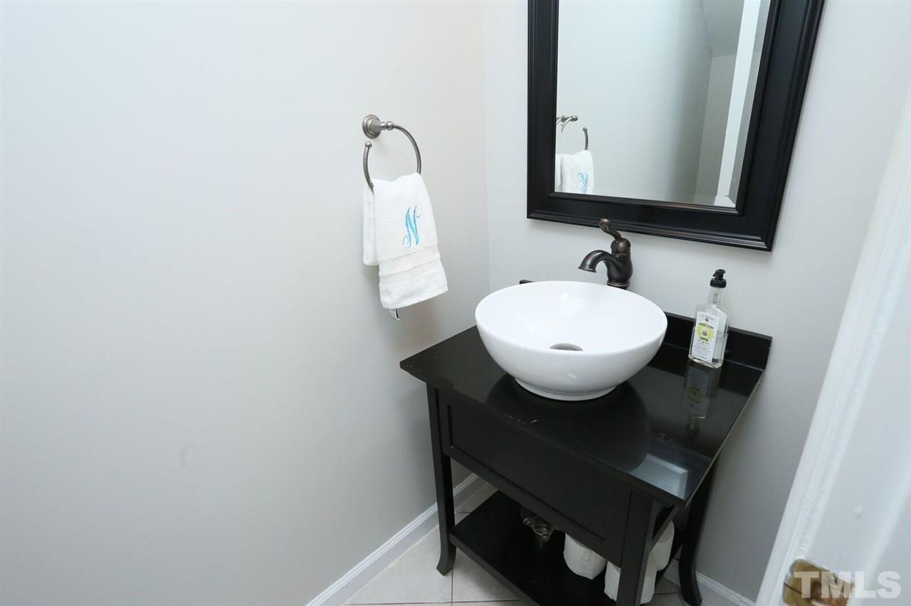 4518 Hamptonshire Drive Raleigh, NC 27613 - Photo 13 of 24 a bathroom with a sink a mirror and toilet