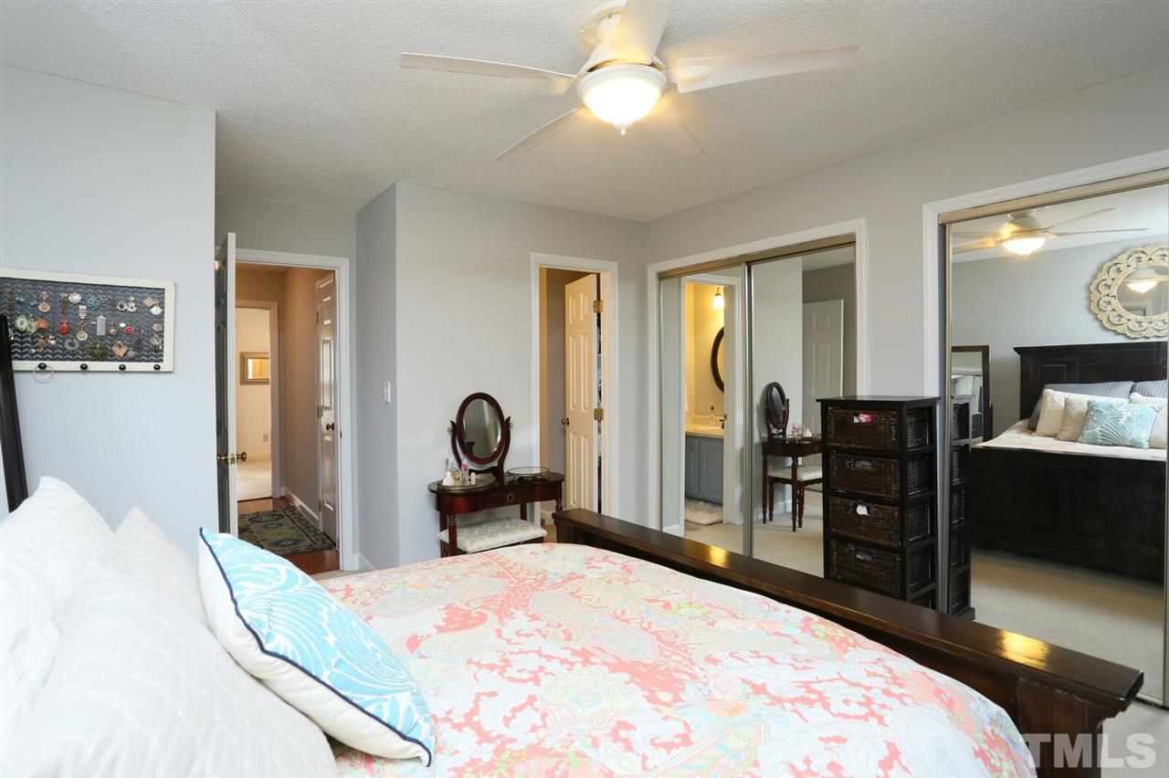 4518 Hamptonshire Drive Raleigh, NC 27613 - Photo 15 of 24 a bedroom with a bed and wooden floor