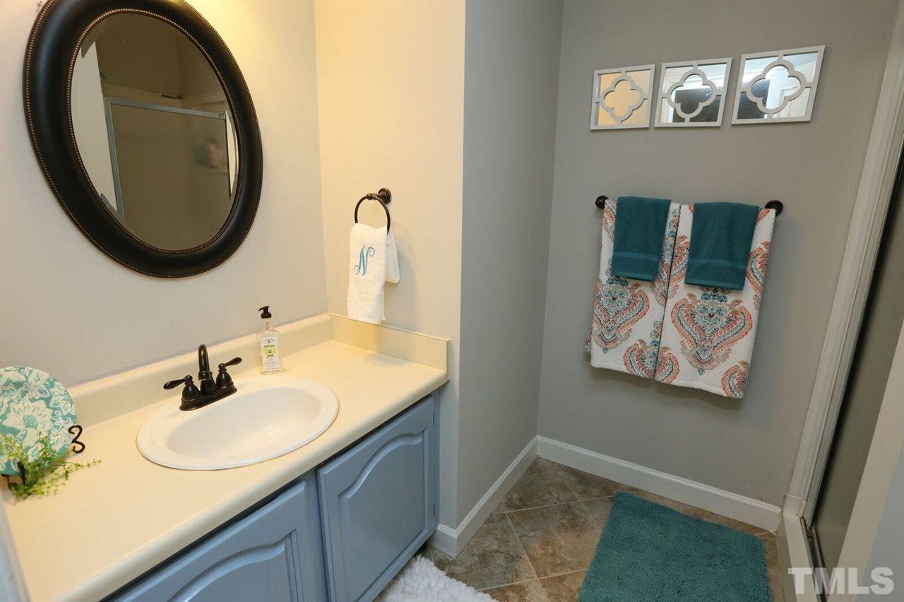 4518 Hamptonshire Drive Raleigh, NC 27613 - Photo 16 of 24 a bathroom with a sink and a mirror