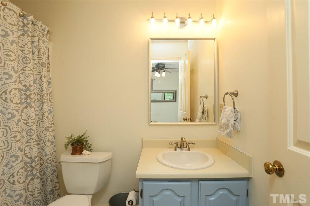 4518 Hamptonshire Drive Raleigh, NC 27613 - Photo 18 of 24 a bathroom with a sink a toilet and mirror