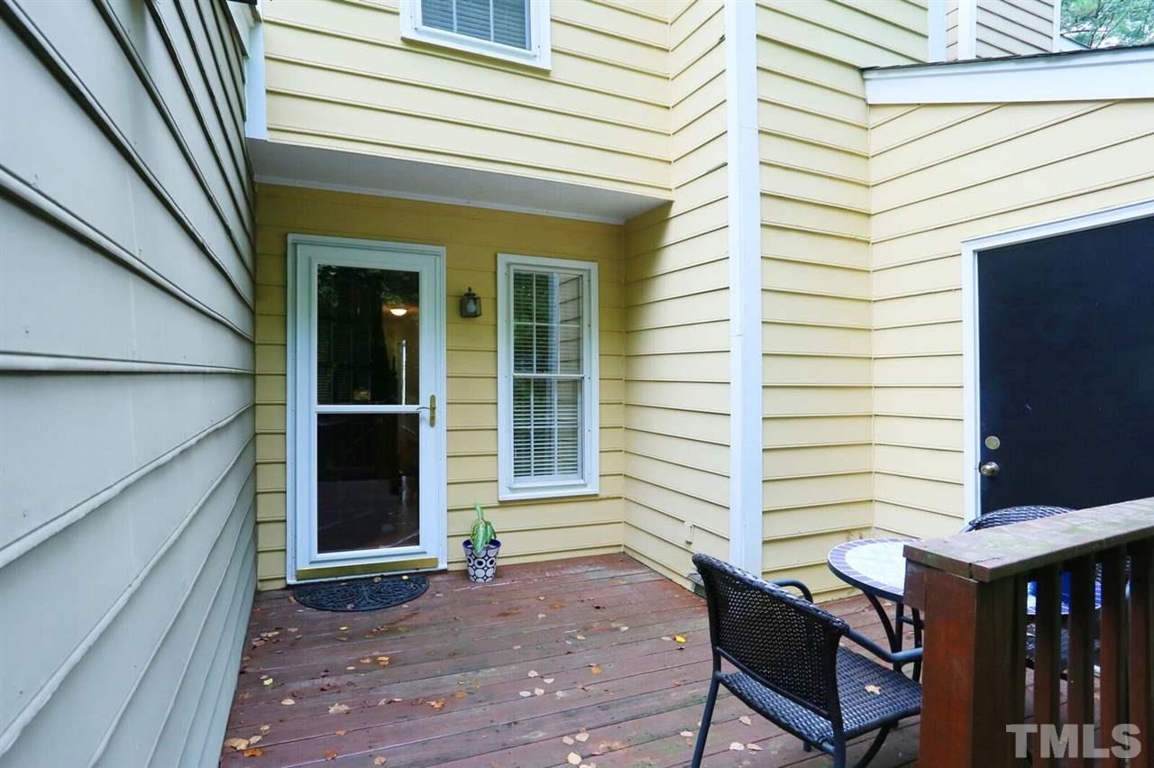 4518 Hamptonshire Drive Raleigh, NC 27613 - Photo 19 of 24 a view of a house with a door and wooden bench