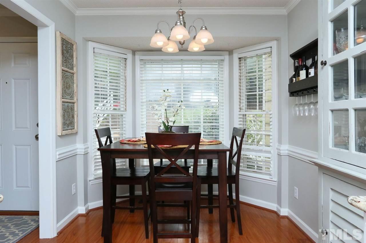 4518 Hamptonshire Drive Raleigh, NC 27613 - Photo 7 of 24 a view of a dining room with furniture window and wooden floor