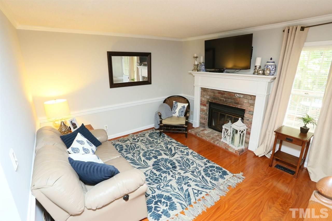 4518 Hamptonshire Drive Raleigh, NC 27613 - Photo 9 of 24 a living room with furniture and a fireplace