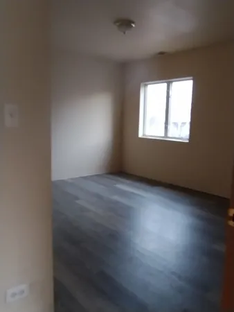 a white toilet sitting next to a bathroom sink and vanity
