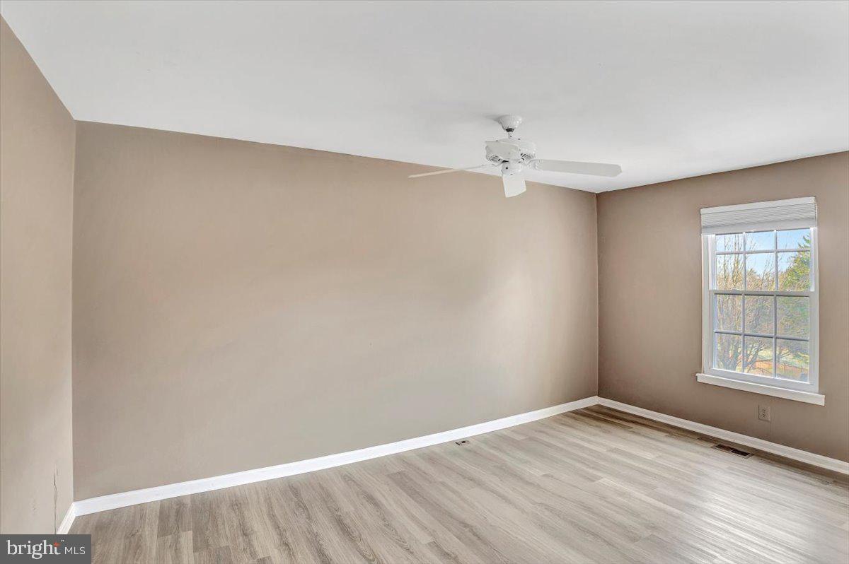 8530 London Bridge Way Lutherville-Timonium, MD 21093 - Photo 13 of 23 wooden floor in an empty room with a window