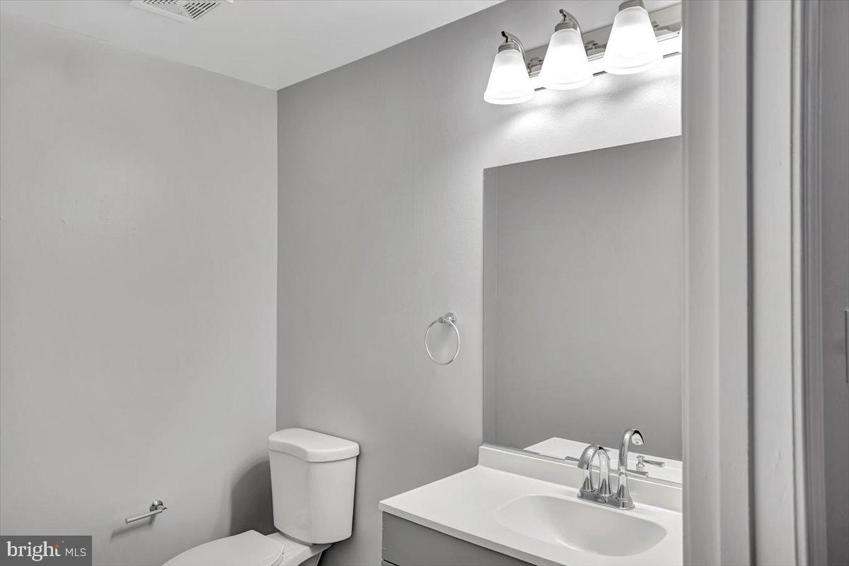 8530 London Bridge Way Lutherville-Timonium, MD 21093 - Photo 18 of 23 a bathroom with a toilet sink and mirror