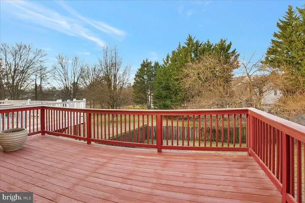 a balcony with wooden floor and fence