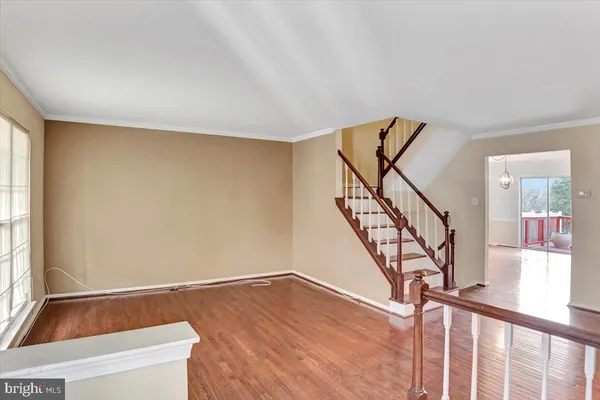 a view of a room with wooden floor and staircase