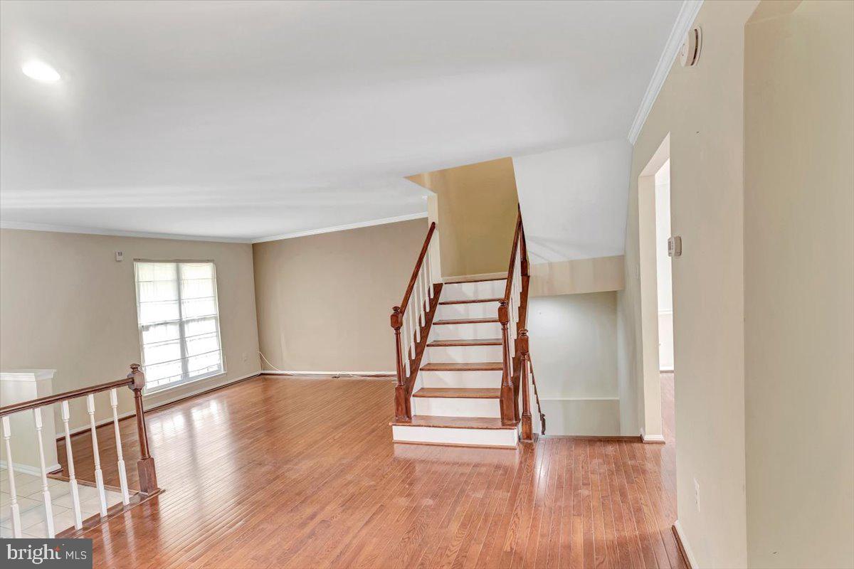 8530 London Bridge Way Lutherville-Timonium, MD 21093 - Photo 7 of 23 a view of empty room with wooden floor and fan
