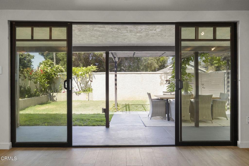 240 North Padre Juan Avenue Ojai, CA 93023 - Photo 13 of 50 a view of a glass door with a floor to ceiling window next to a yard