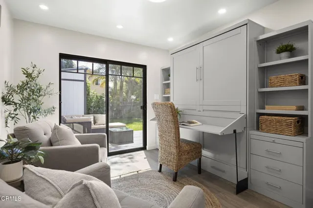 a living room with furniture closet and large window