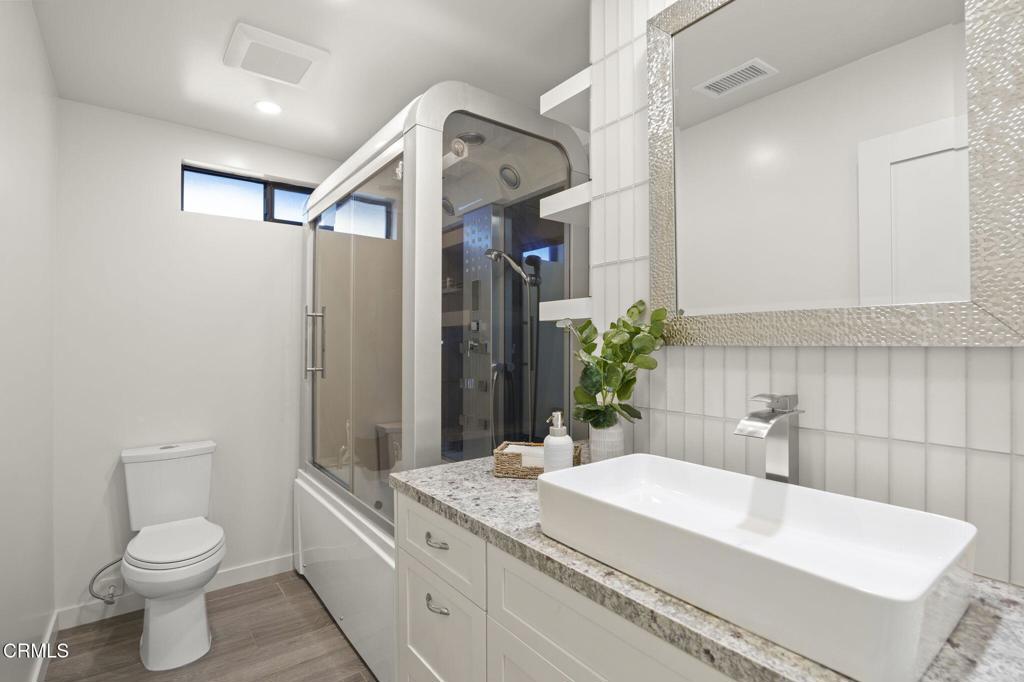 240 North Padre Juan Avenue Ojai, CA 93023 - Photo 16 of 50 a bathroom with a granite countertop sink a toilet and mirror