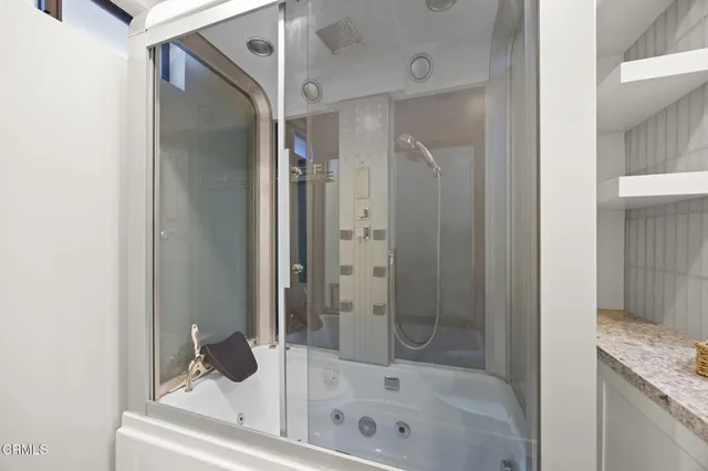 a bathroom with a tub and shower