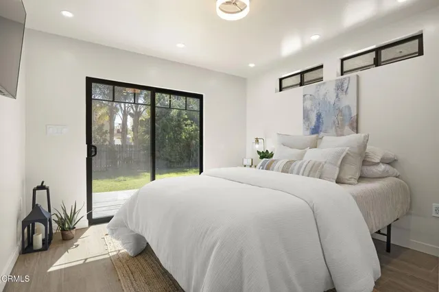 a bedroom with a large bed and a large window