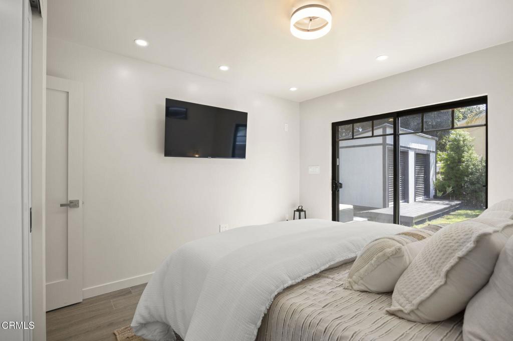 240 North Padre Juan Avenue Ojai, CA 93023 - Photo 19 of 50 a bedroom with a large bed and a flat screen tv