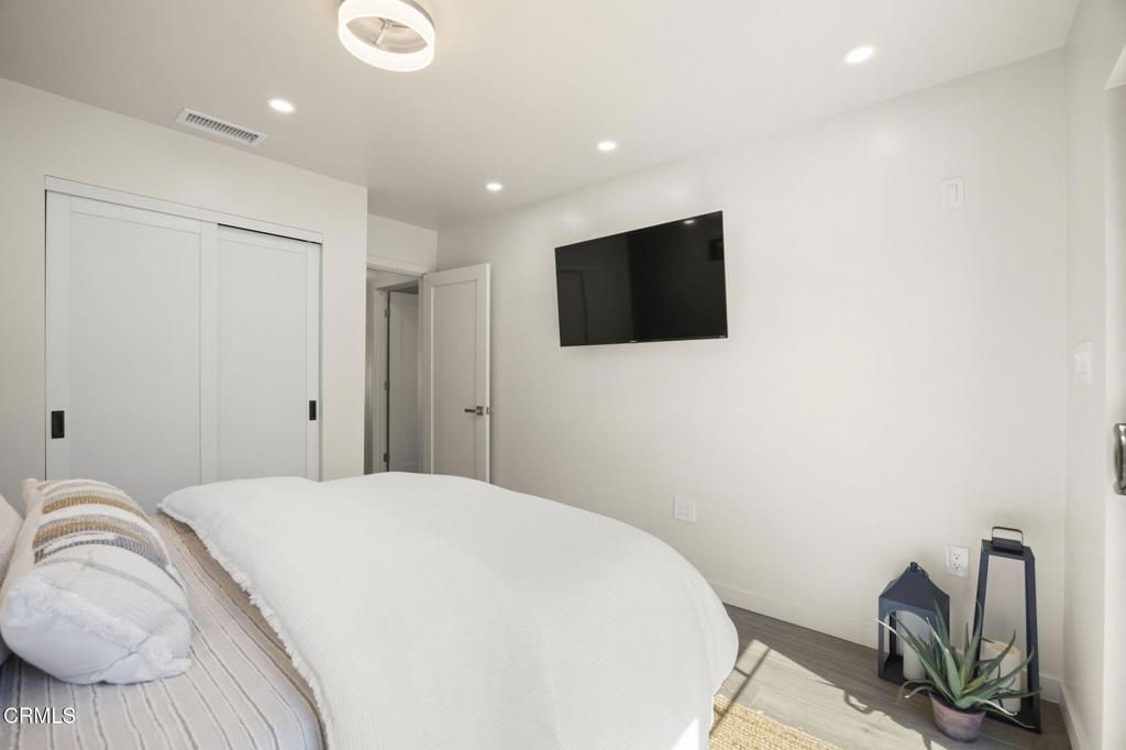 240 North Padre Juan Avenue Ojai, CA 93023 - Photo 20 of 50 a bedroom with a bed and a flat screen tv