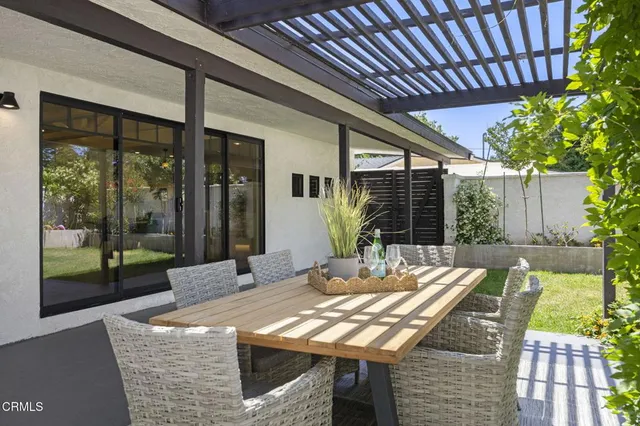 a view of an outside dining space with furniture