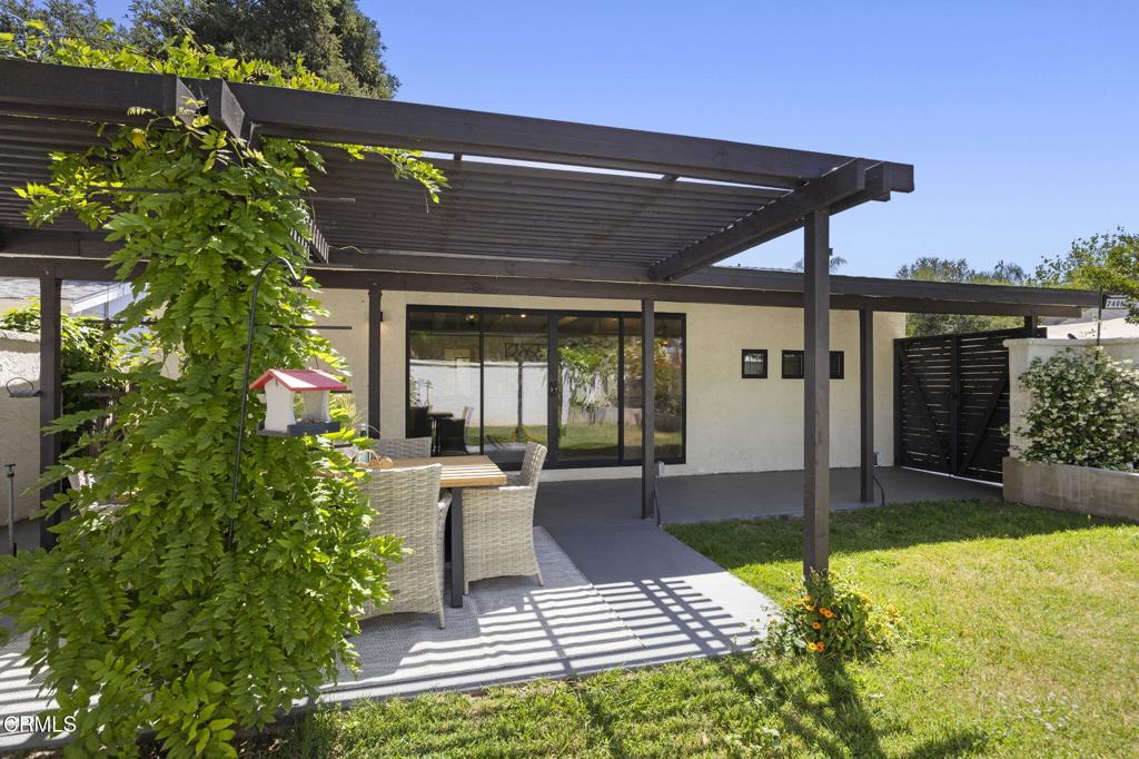 240 North Padre Juan Avenue Ojai, CA 93023 - Photo 25 of 50 a view of a patio with table and chairs potted plants and floor to ceiling window