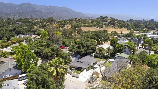 an aerial view of a house with a yard