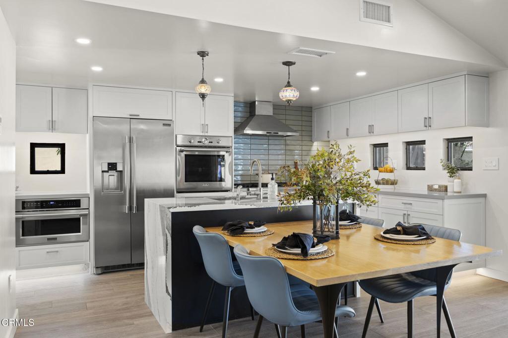 240 North Padre Juan Avenue Ojai, CA 93023 - Photo 5 of 50 a kitchen with a table chairs refrigerator and microwave