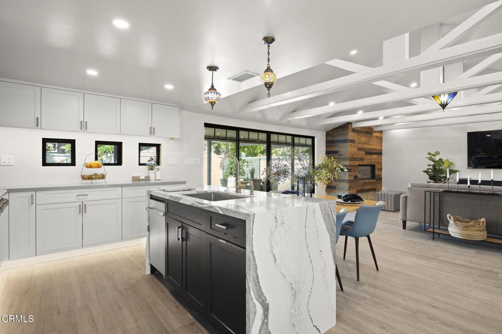 240 North Padre Juan Avenue Ojai, CA 93023 - Photo 6 of 50 a kitchen with stainless steel appliances kitchen island granite countertop a table chairs and a refrigerator