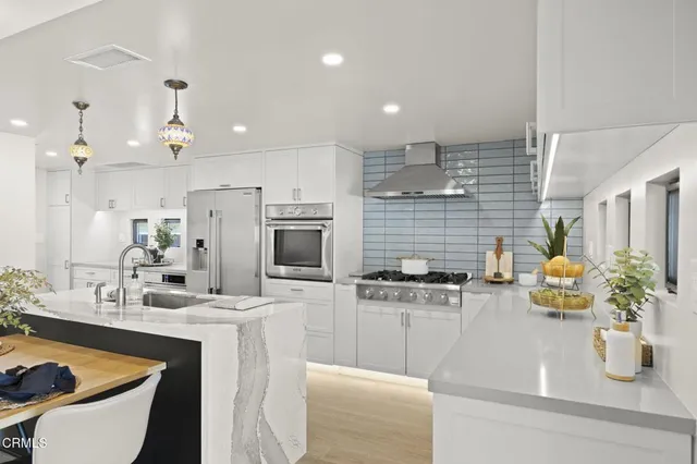 a kitchen with stainless steel appliances kitchen island granite countertop a sink and cabinets