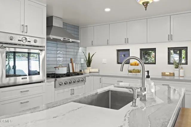 a kitchen with granite countertop a sink cabinets and window