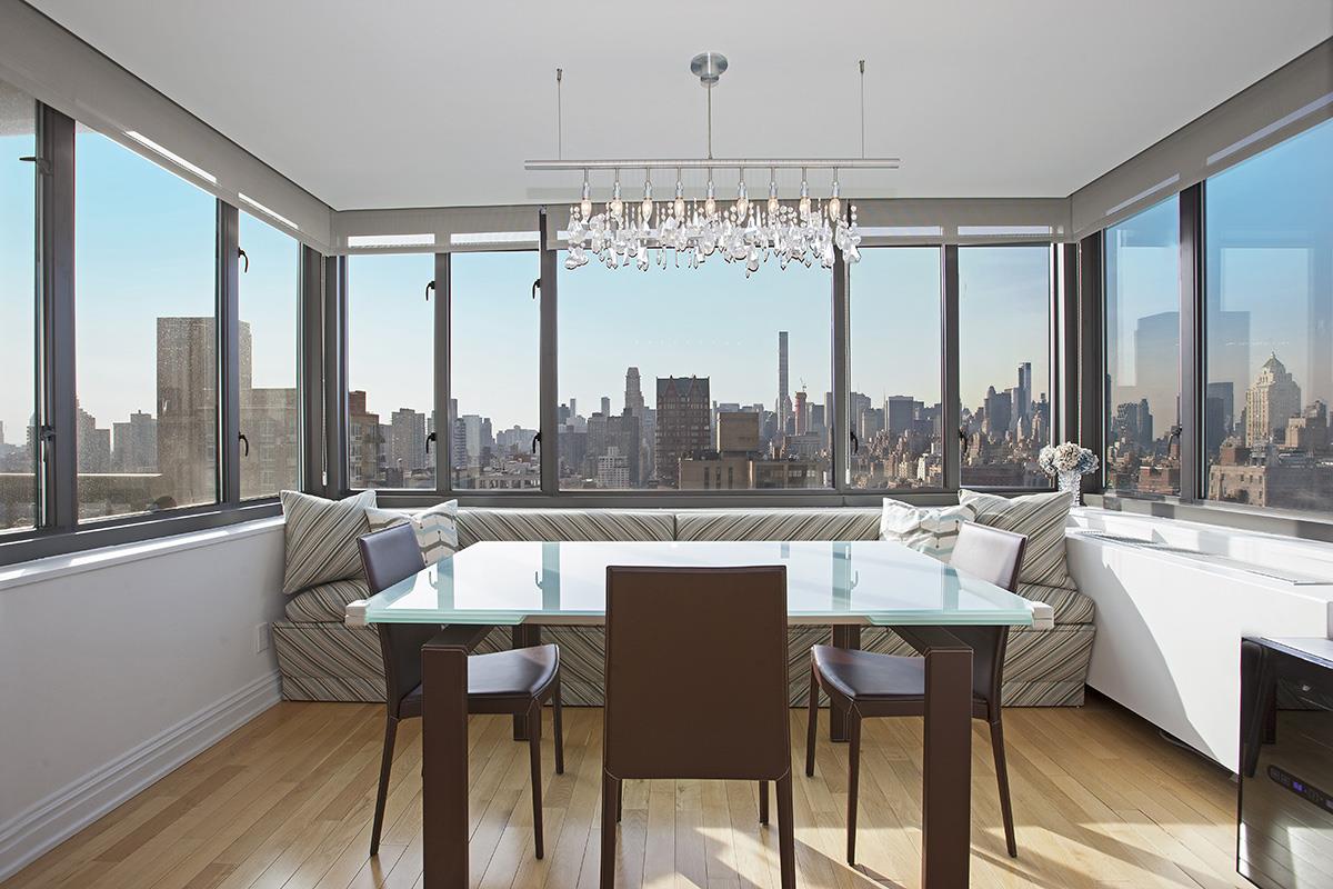 a very nice looking dining room with a large window and dining table