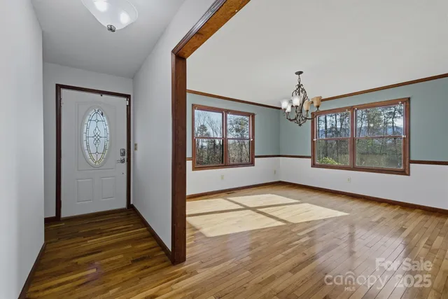 a view of a room with wooden floor and windows