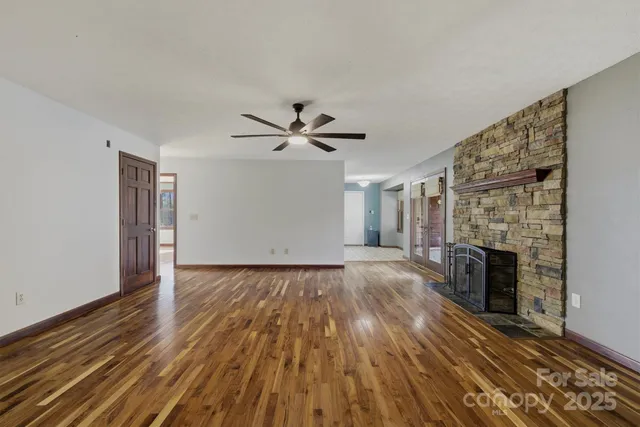 wooden floor in an empty room with a fireplace