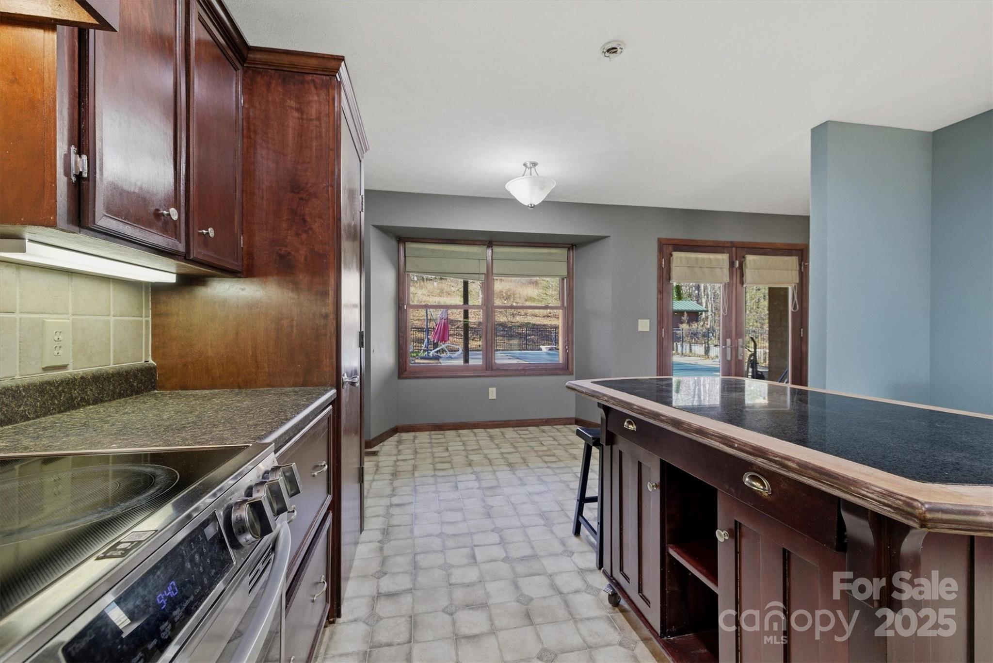 5341 Reese Store Avenue Morganton, NC 28655 - Photo 21 of 45 a kitchen with granite countertop a sink a stove and cabinets